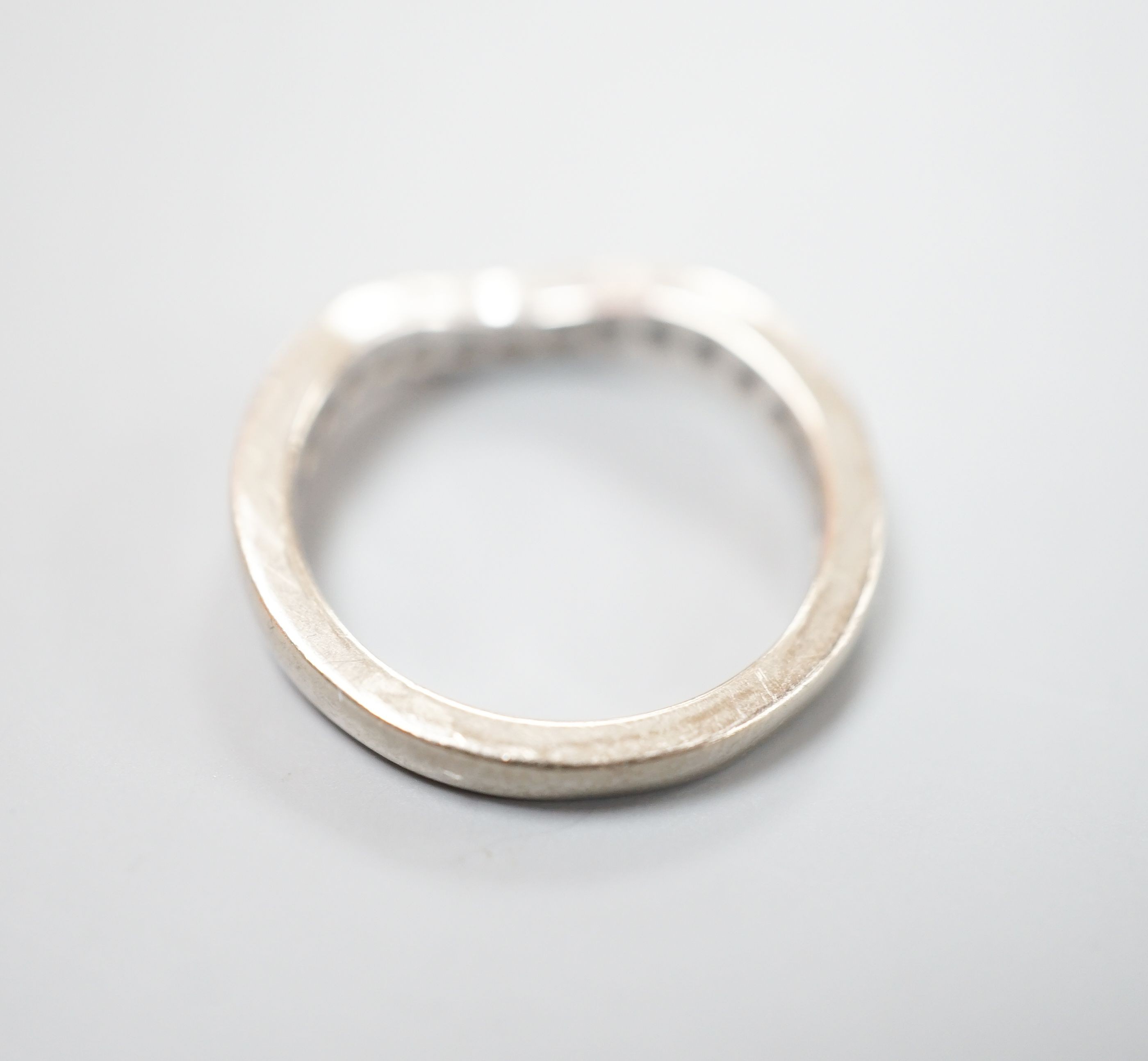 A modern 18ct white gold and diamond set shaped half eternity ring, size H/I, gross weight 3.3 grams.